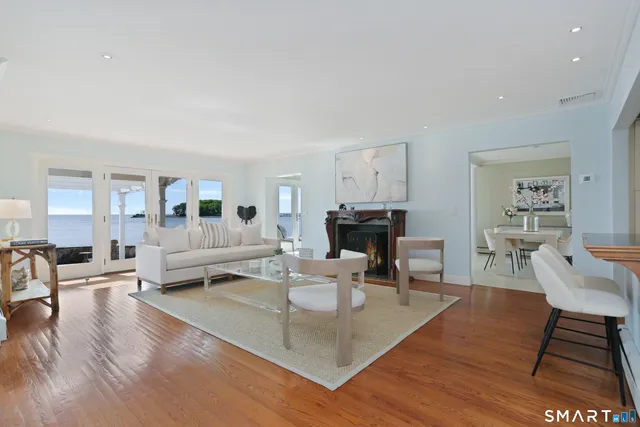 a living room with fireplace furniture and a wooden floor