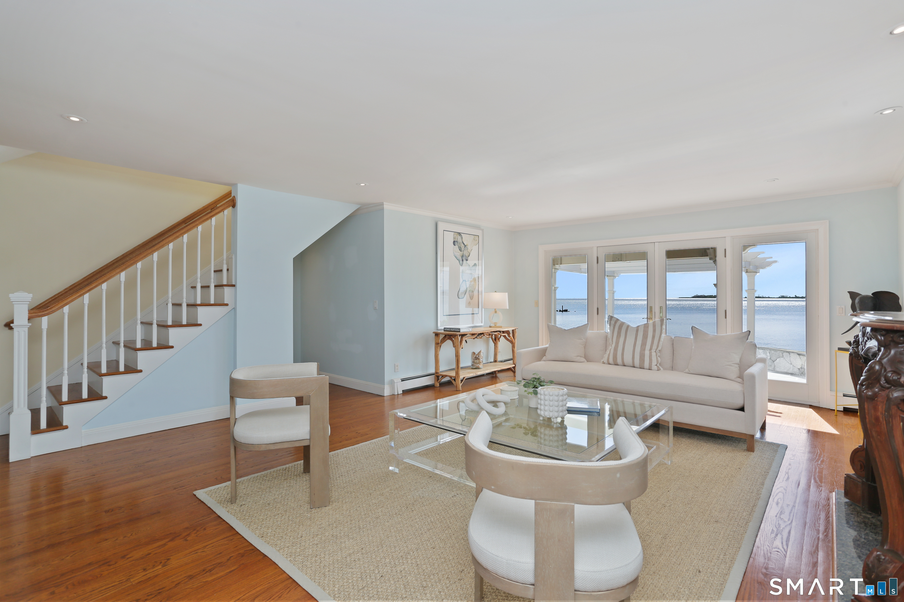 34 Shorehaven Road Norwalk, CT 06855 - Photo 15 of 40 a living room with couches and a dining table with wooden floor