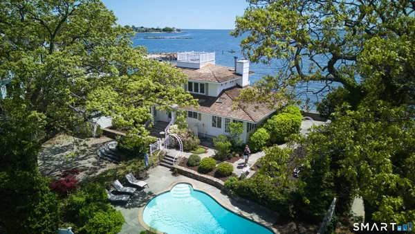 an aerial view of a house with a yard and garden