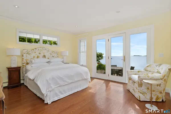 a bedroom with a bed and large window