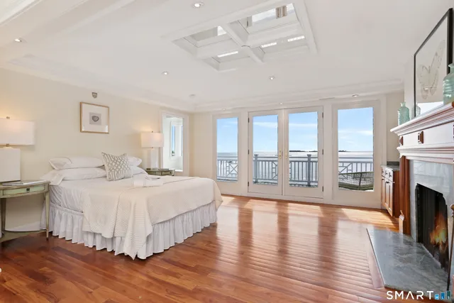 a spacious bedroom with a large bed and a fireplace