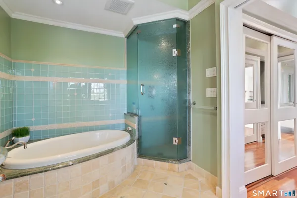 a bathroom with a tub and shower