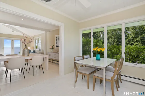a view of a dining room with furniture and window