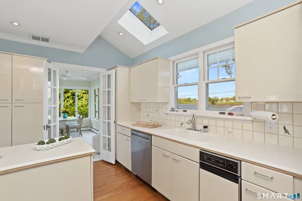 a kitchen with a sink stove and cabinets