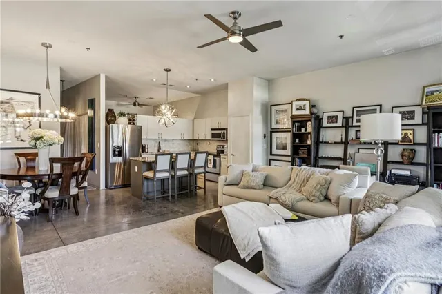 a living room with furniture kitchen view and a dining table
