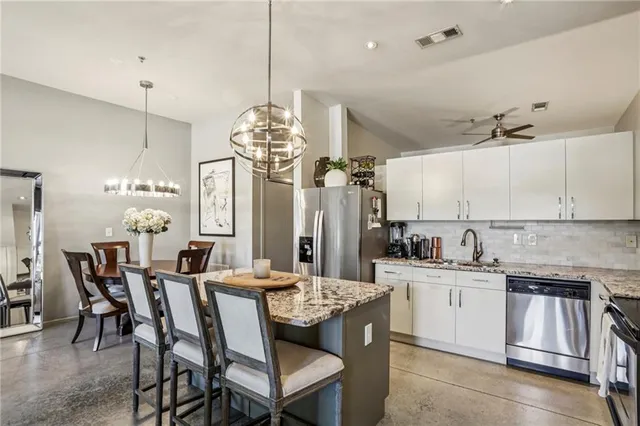 a large kitchen with a table and chairs