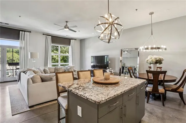 a living room with furniture a chandelier and a flat screen tv