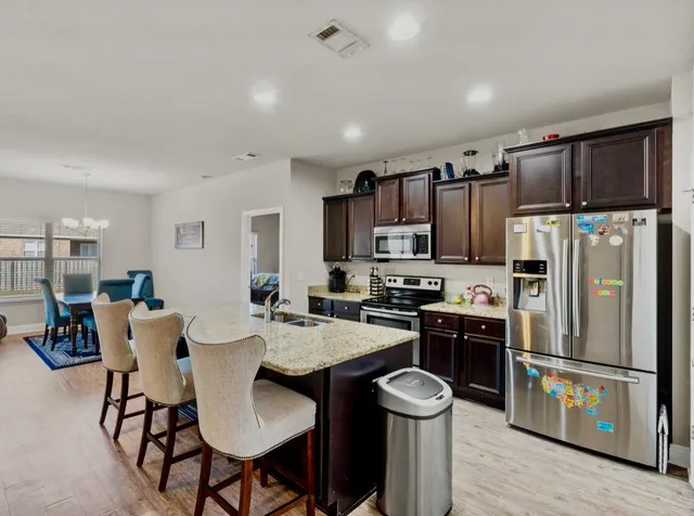 a spacious bedroom with a bed and a flat screen tv