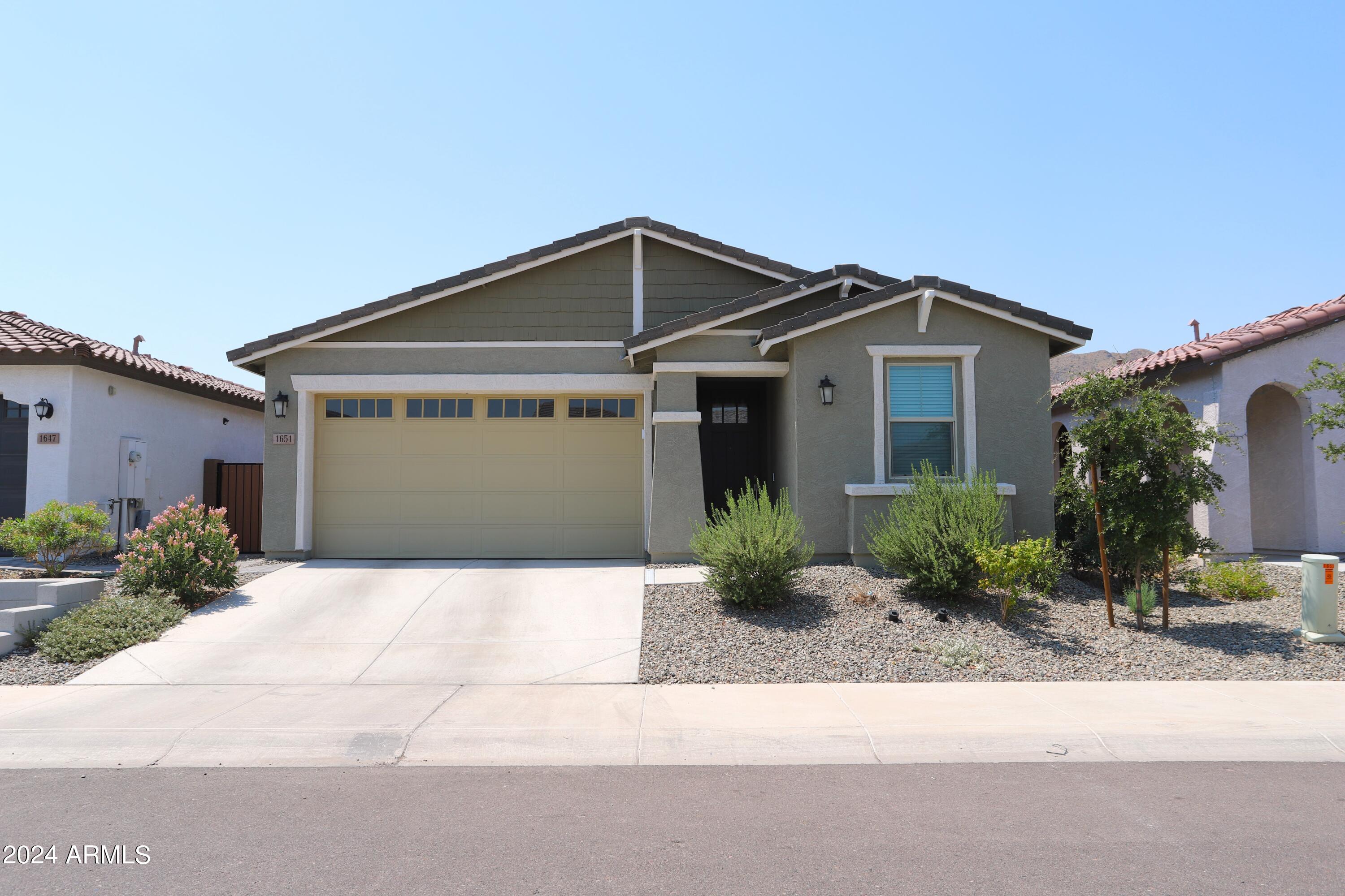 a front view of a house with a yard and garage
