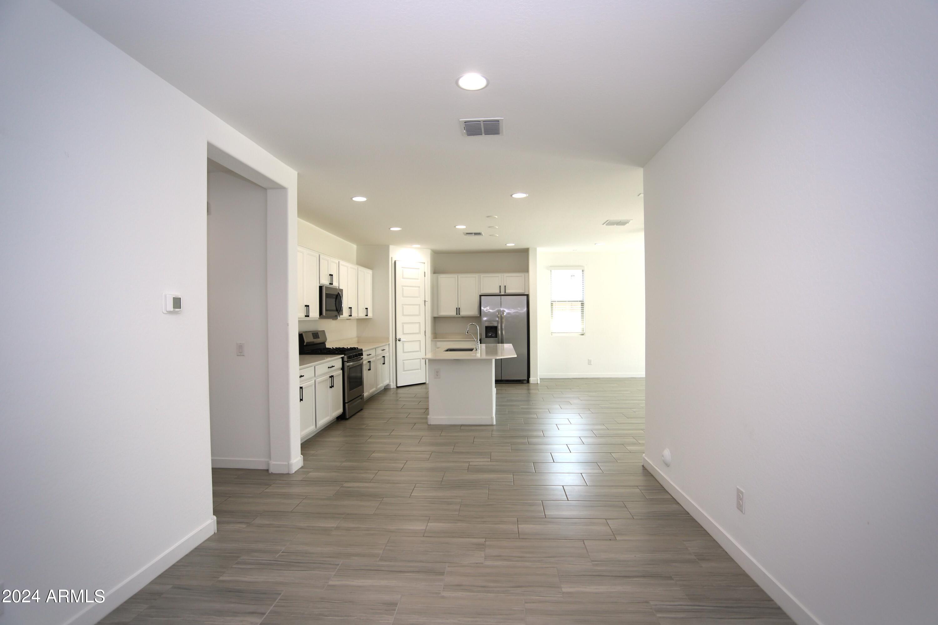 1651 West Piedmont Road Phoenix, AZ 85041 - Photo 18 of 46 a view of a kitchen with wooden floor