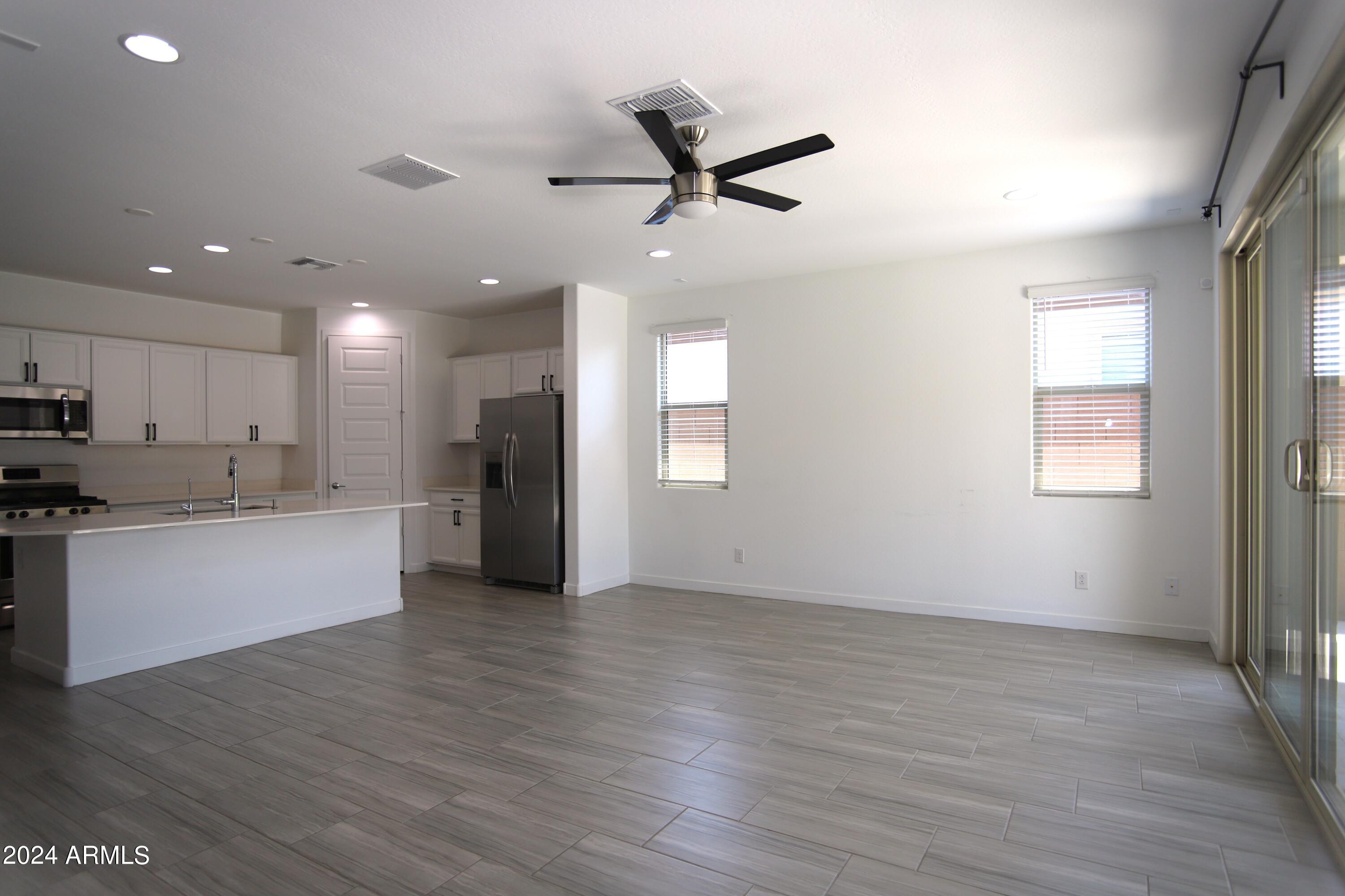1651 West Piedmont Road Phoenix, AZ 85041 - Photo 25 of 46 a view of an empty room with wooden floor and a window