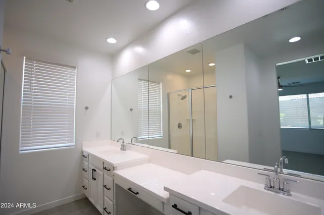 a bathroom with a granite countertop sink mirror and double