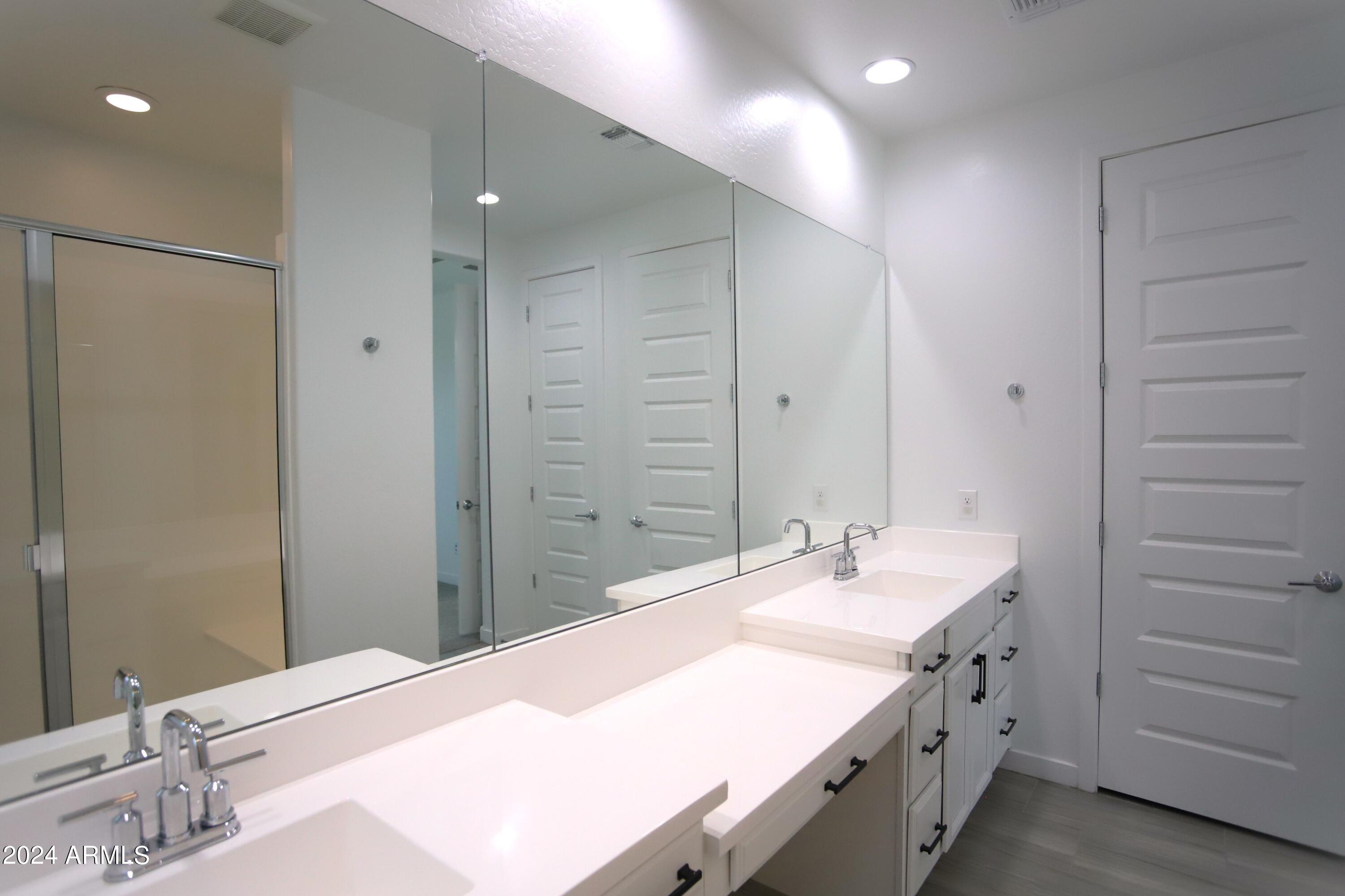 1651 West Piedmont Road Phoenix, AZ 85041 - Photo 30 of 46 a bathroom with a granite countertop sink and a mirror