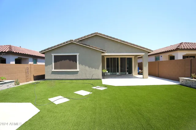a front view of house with yard and outdoor seating