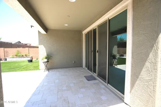 a view of a back yard from a corridor