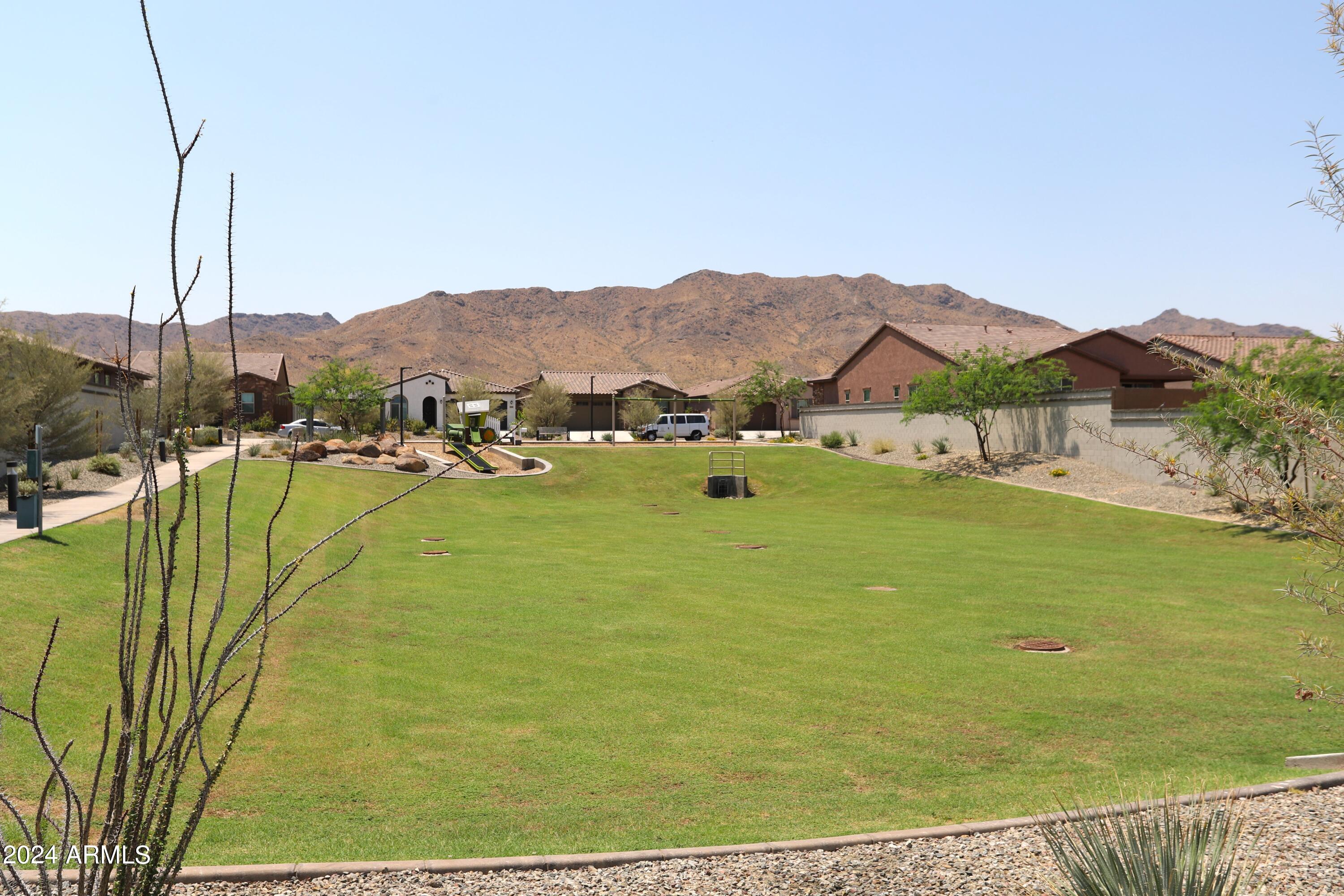 1651 West Piedmont Road Phoenix, AZ 85041 - Photo 44 of 46 a view of a lake with a mountain in the background