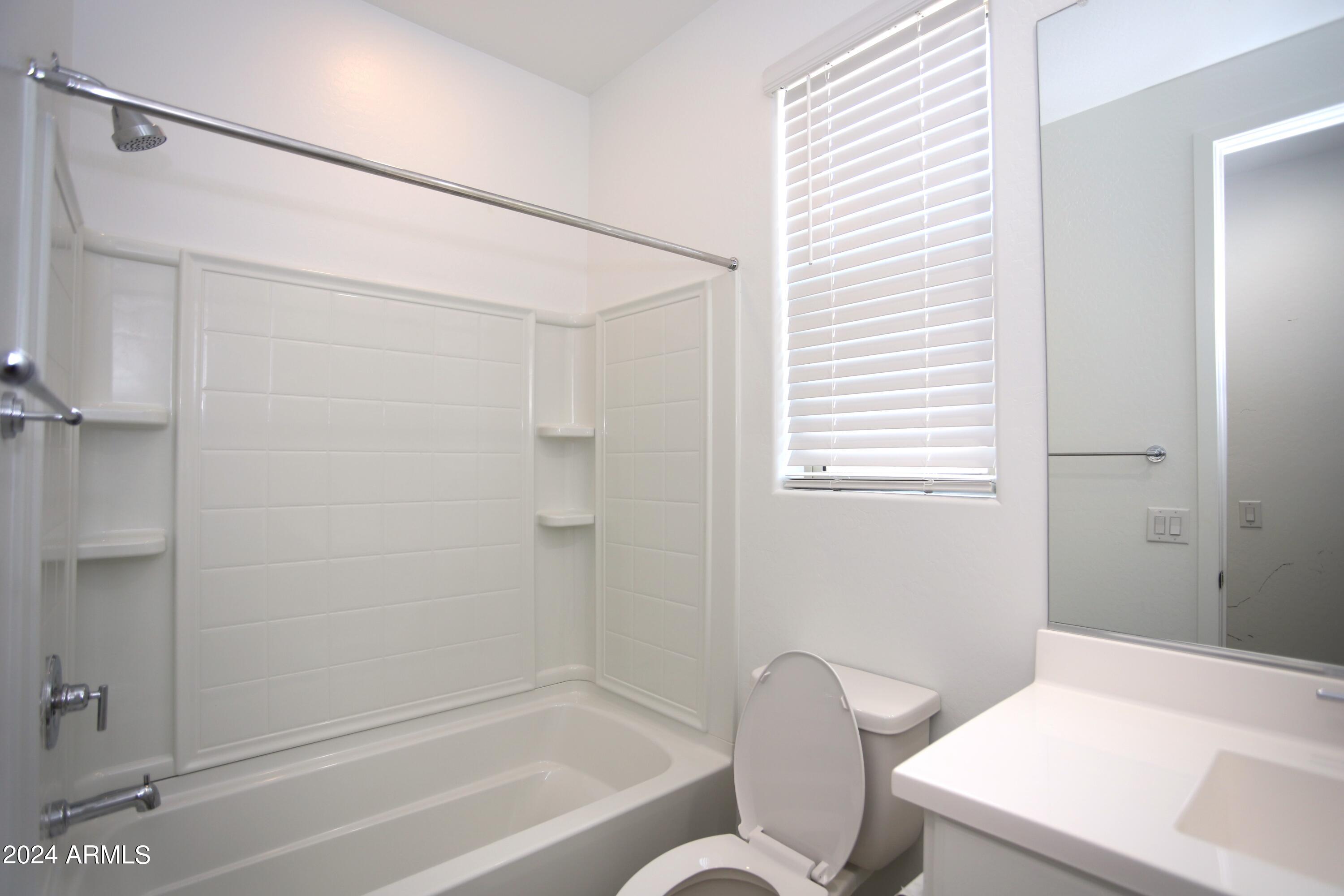 1651 West Piedmont Road Phoenix, AZ 85041 - Photo 9 of 46 a bathroom with a toilet and a bathtub