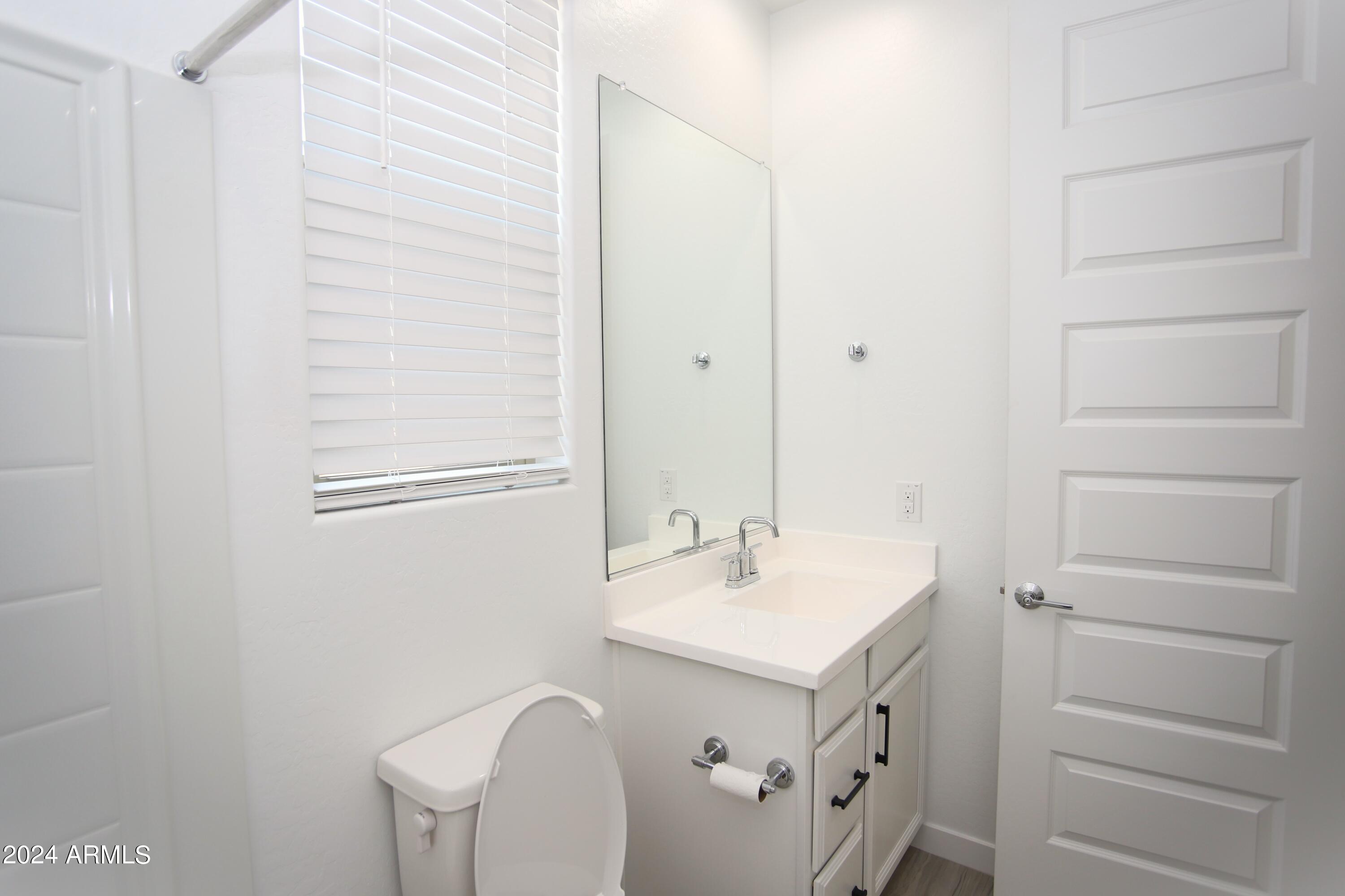 1651 West Piedmont Road Phoenix, AZ 85041 - Photo 10 of 46 a bathroom with a sink and a mirror