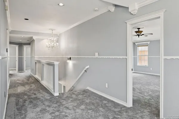 wooden floor with white walls and stairs