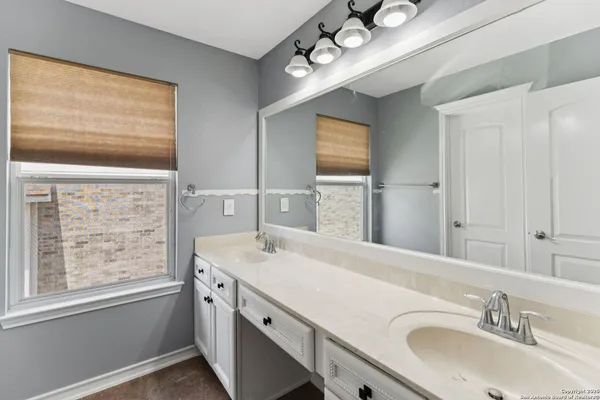 a bathroom with a sink double vanity and a mirror