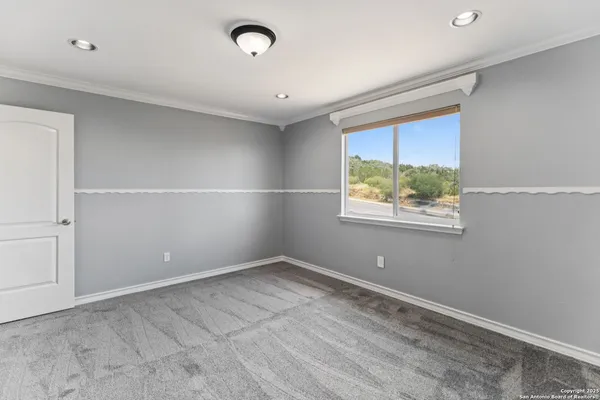 a view of an empty room with a window