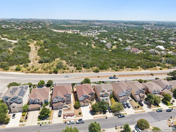 an aerial view of residential houses with outdoor space