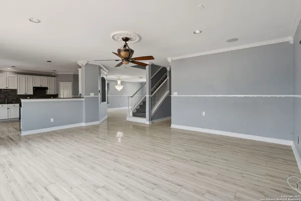 a view of a room with wooden floor and stairs