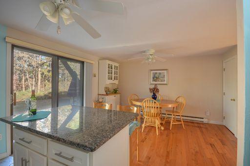 195 Falmouth Road, Unit 14C Mashpee, MA 02649 - Photo 11 of 27 a dining room with wooden floor and window