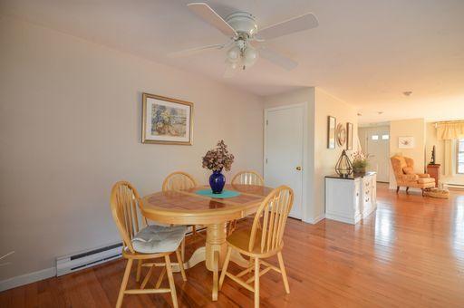 195 Falmouth Road, Unit 14C Mashpee, MA 02649 - Photo 13 of 27 a dining room with furniture and wooden floor