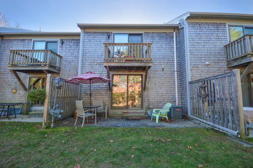 195 Falmouth Road, Unit 14C Mashpee, MA 02649 - Photo 23 of 27 a front view of a house with a garden