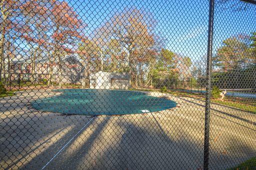 195 Falmouth Road, Unit 14C Mashpee, MA 02649 - Photo 26 of 27 a view of backyard and tree