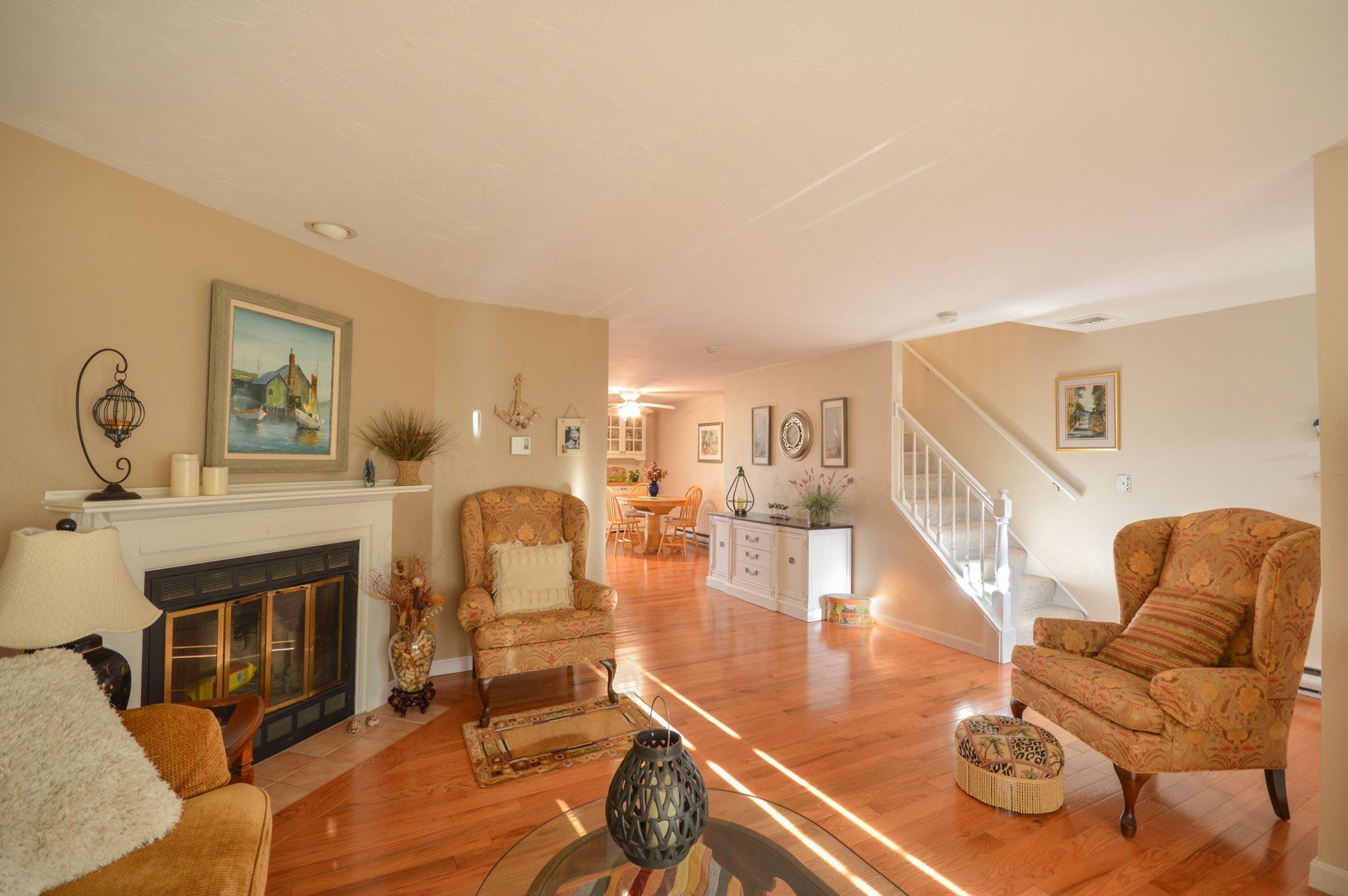 195 Falmouth Road, Unit 14C Mashpee, MA 02649 - Photo 7 of 27 a living room with furniture and a fireplace
