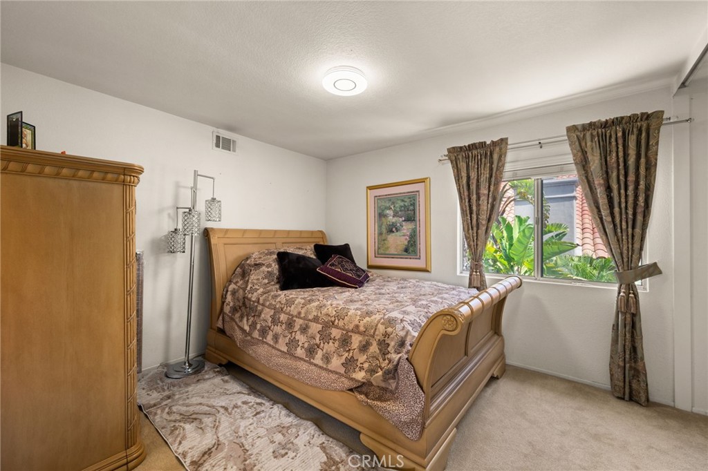 950 Chantel Drive Corona, CA 92879 - Photo 19 of 27 a bedroom with a bed dresser and a window