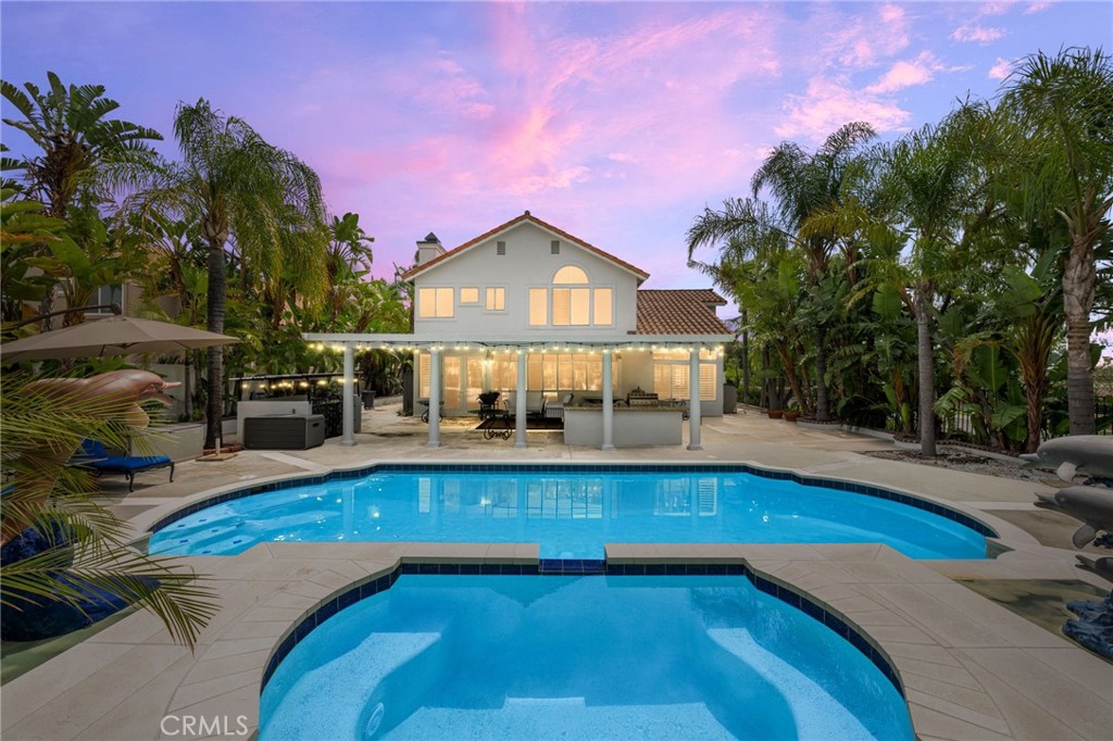 950 Chantel Drive Corona, CA 92879 - Photo 2 of 27 a view of a swimming pool with lawn chairs under an umbrella