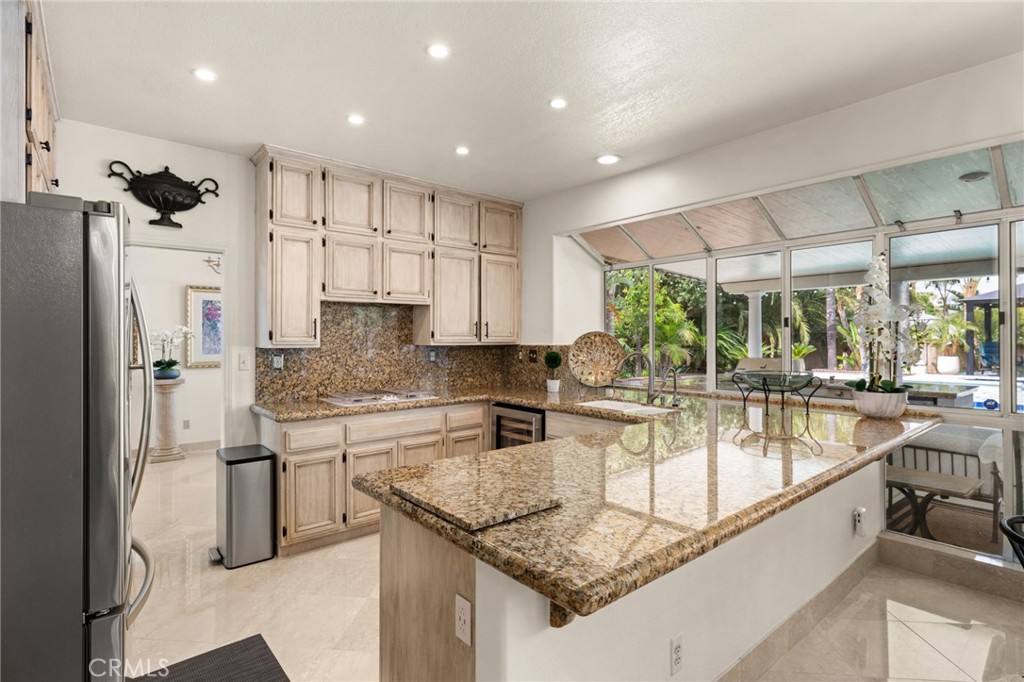 950 Chantel Drive Corona, CA 92879 - Photo 10 of 27 a kitchen with stainless steel appliances granite countertop a sink refrigerator and cabinets