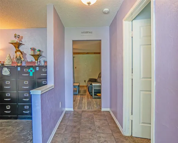 a view of a hallway view with living room and front door