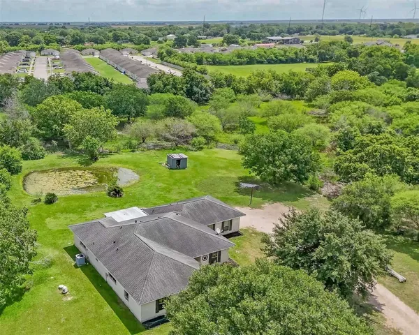 an aerial view of a house with a yard