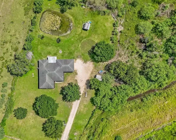 an aerial view of a house with a yard