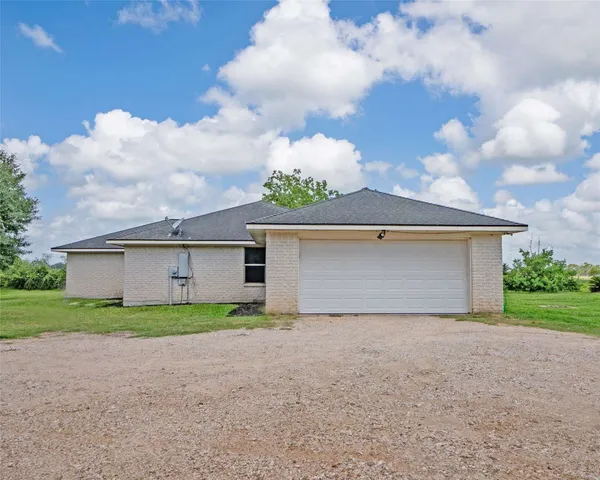 a view of a house with a yard and garage