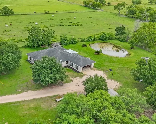 an aerial view of huge green field with lots of green space