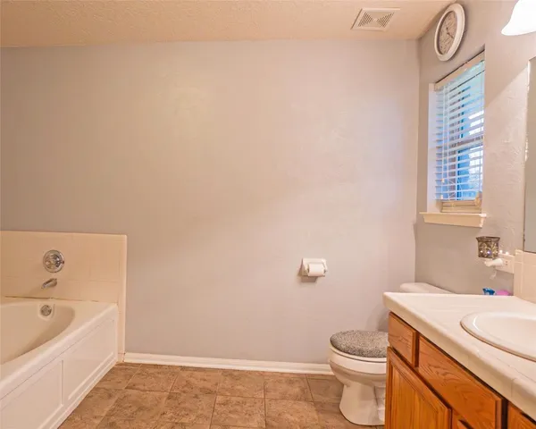 a bathroom with a sink a toilet and bathtub