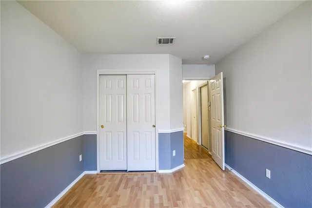 a view of hallway with wooden floor