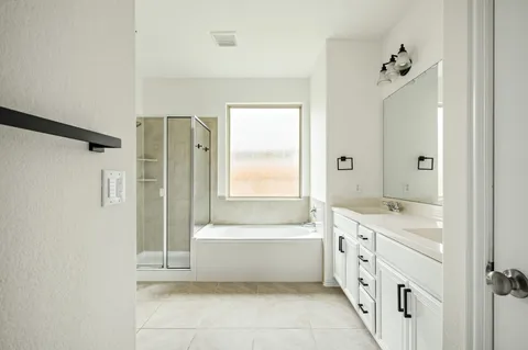 a bathroom with a tub sink and mirror