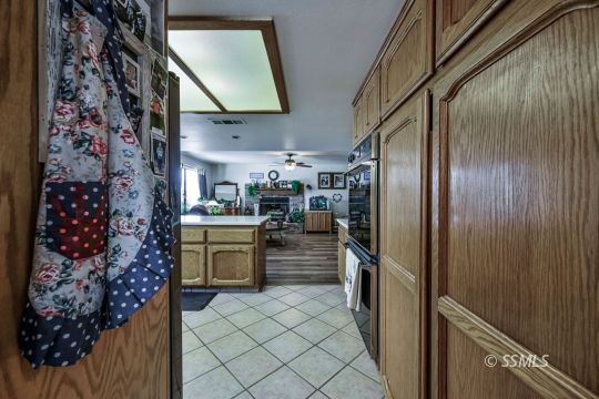 1213 Andrea Court Ridgecrest, CA 93555 - Photo 22 of 50 a kitchen with a refrigerator and a stove