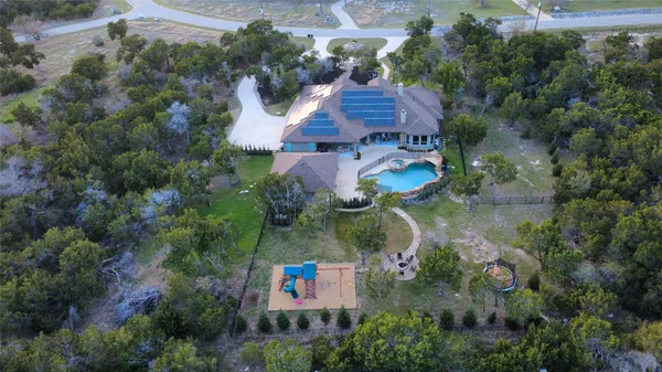 an aerial view of residential house with outdoor space and swimming pool