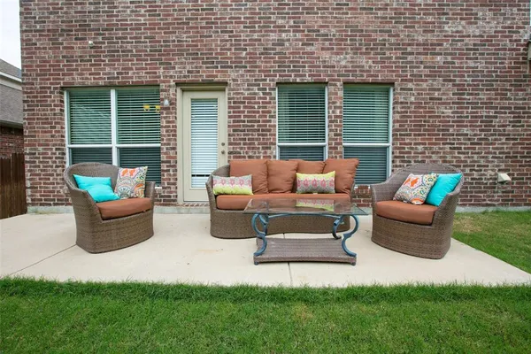 a view of backyard of house with seating space