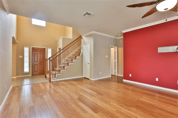a view of an empty room with wooden floor