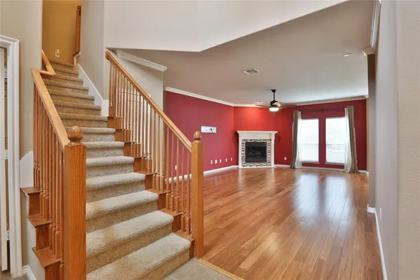 a view of entryway and hall with wooden floor