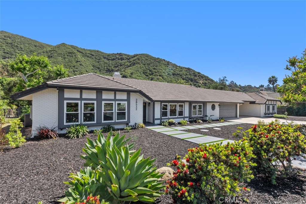 28532 Markuson Road Silverado, CA 92676 - Photo 1 of 1 a front view of a house with a garden