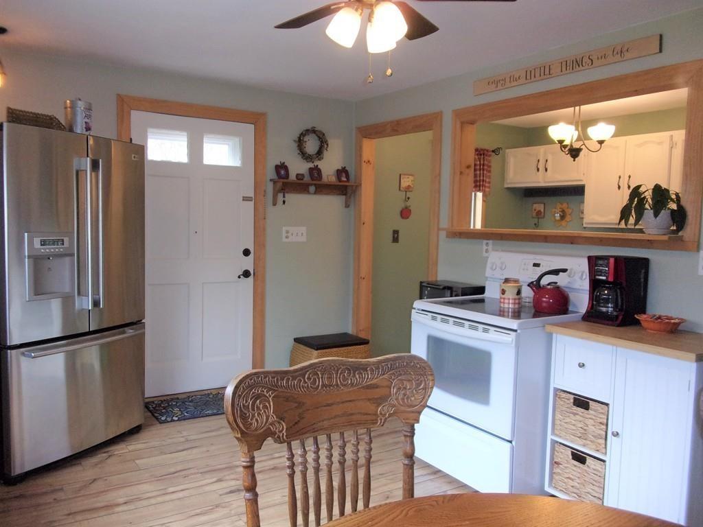158 Osborne Road Ware, MA 01082 - Photo 12 of 31 a kitchen with stainless steel appliances granite countertop a refrigerator a stove and a sink with wooden floor
